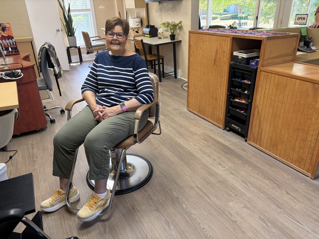 Judy Hunter sits in a salon chair